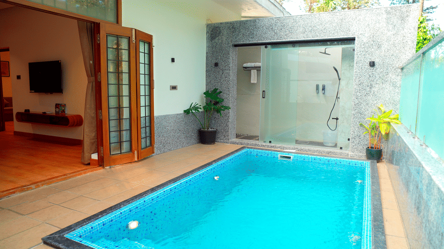 A private pool beside a room with open doors at DNC Shevaroys Resorts and Spa.
