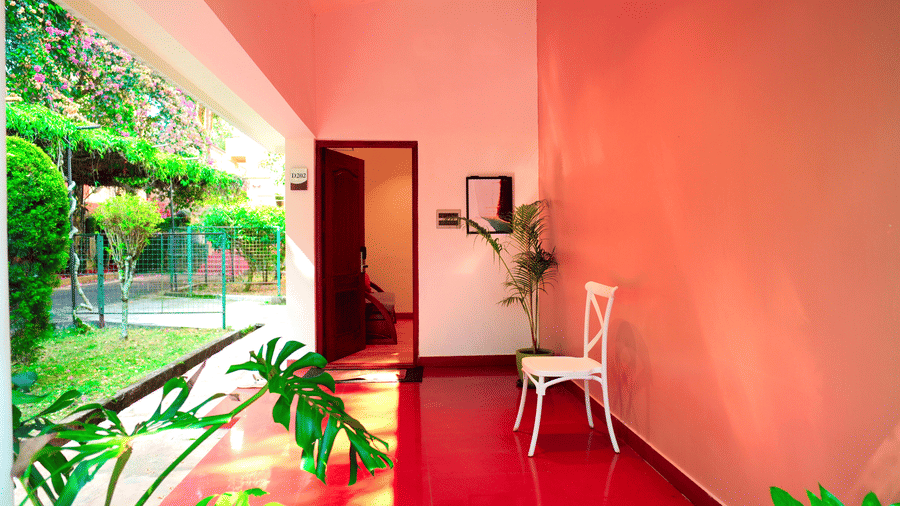 A villa entrance with plants, a pathway, and a chair at DNC Shevaroys Resorts and Spa.