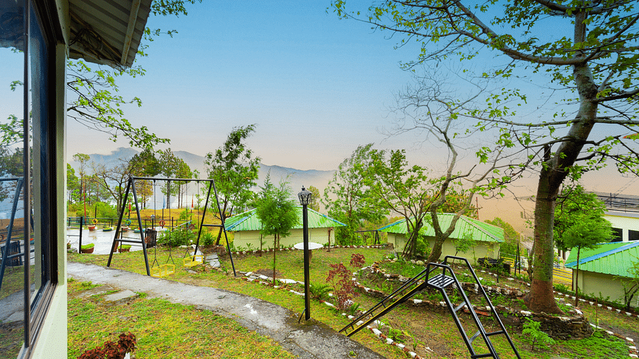 a view of a garden featuring a slide and a swing at Flutter Hotels & Resorts