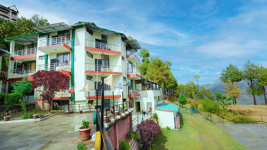 exterior of Flutter Hotels & Resorts surrounded by trees