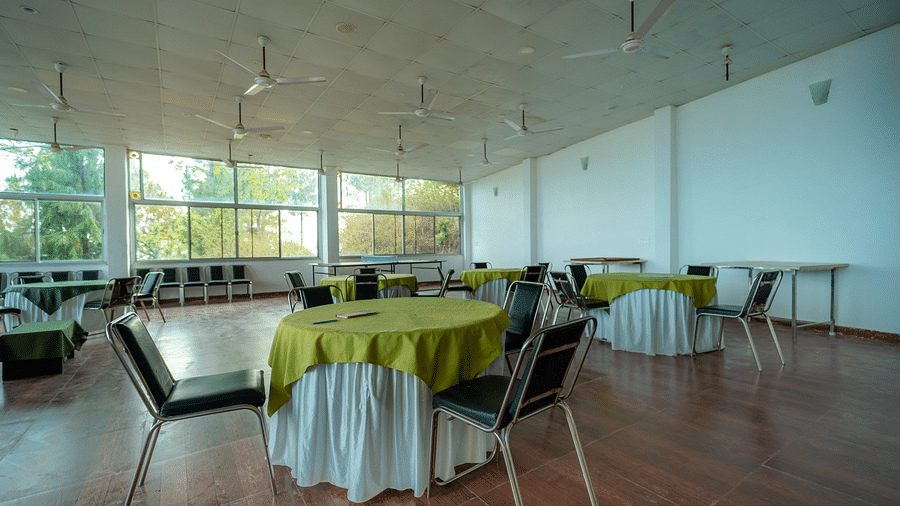tables and chairs placed in the event venue at Flutter Hotels & Resorts surrounded by beautiful view of the valleys