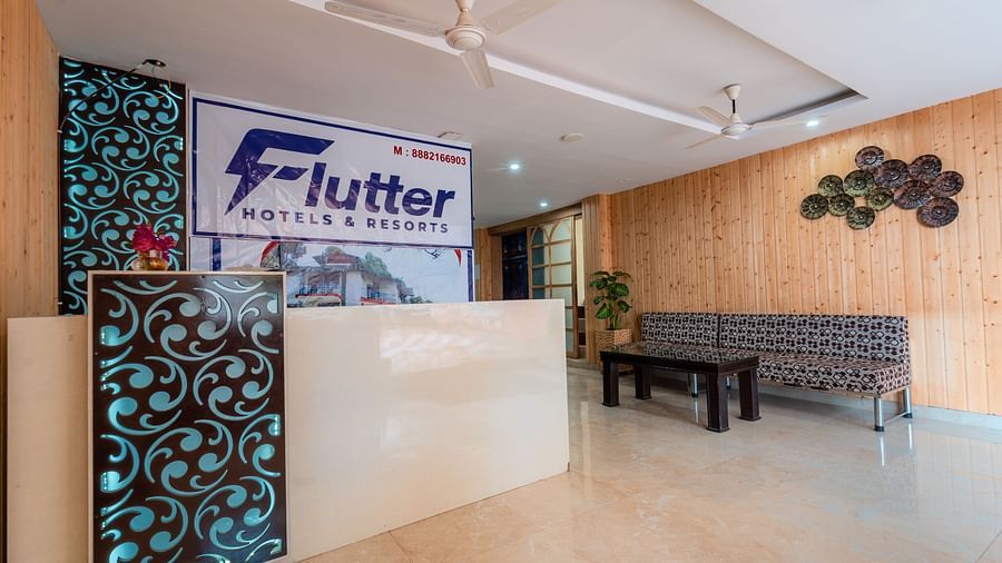 Reception desk at Flutter Hotels and Resorts, Lansdowne with a sofa, table and wooden decors.