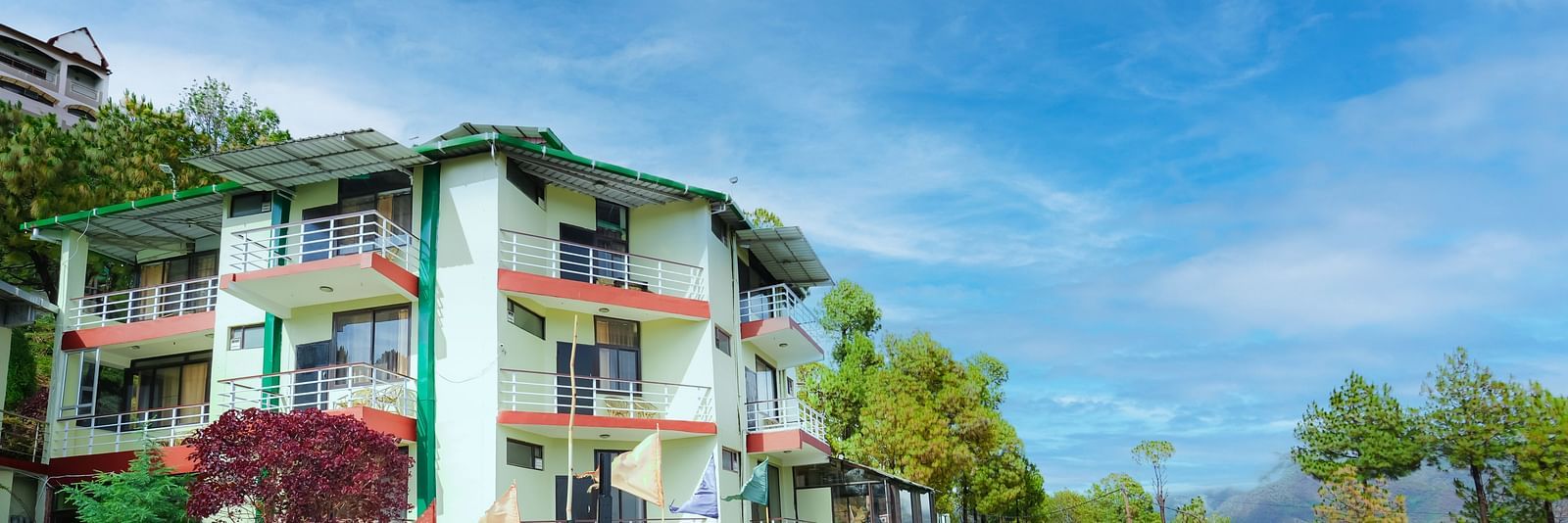 exterior of Flutter Hotels & Resorts surrounded by trees