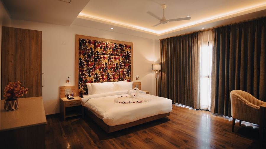 Clarks Inn Express Dehradun - interior view of the suite with king size work table and brown coloured decor