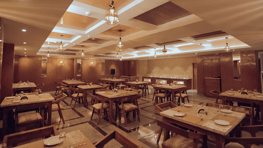 Clarks Inn Express Dehradun - Interior view of the Bridge restaurant with numerous seating options