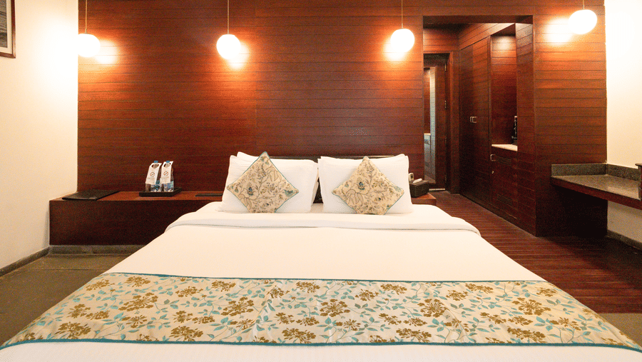 A cozy bedroom with hanging lights and modern interiors, creating a warm atmosphere