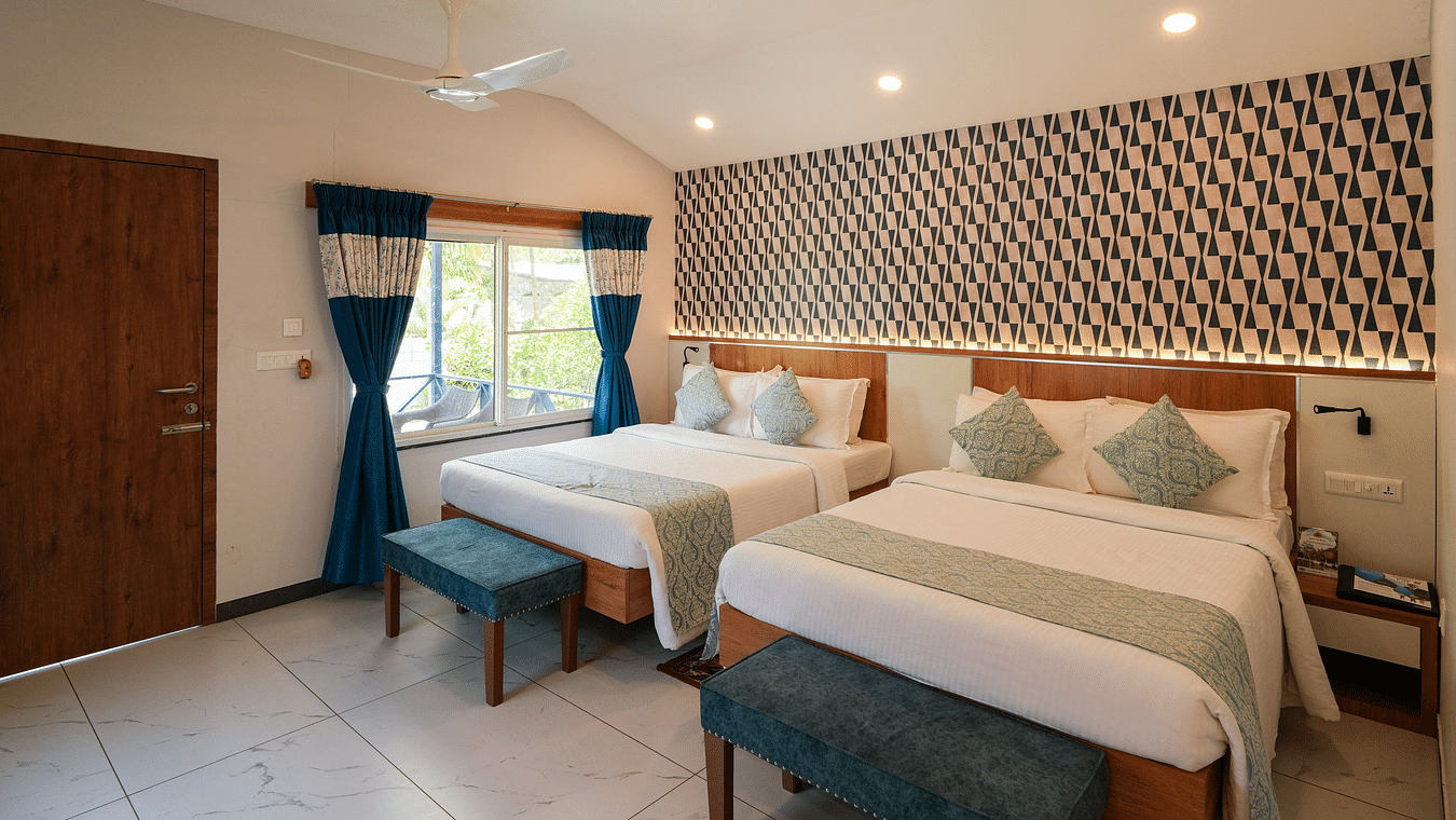 A spacious and well-lit room with comfortable beds and modern decor - MGM Whispering Wind's Resorts