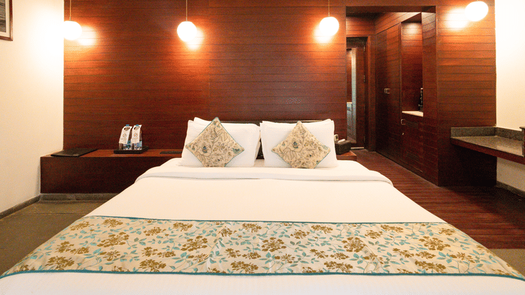 A cozy bedroom with hanging lights and modern interiors, creating a warm atmosphere