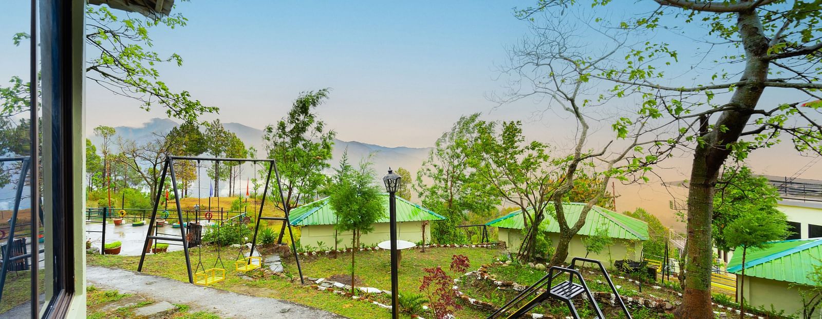 a view of a garden featuring a slide and a swing at Flutter Hotels & Resorts