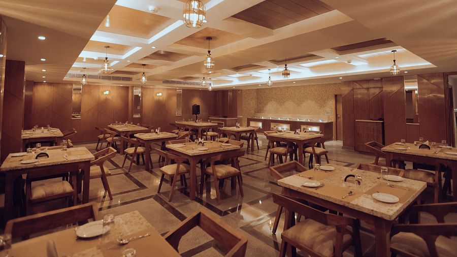 Clarks Inn Express Dehradun - Interior view of the Bridge restaurant with numerous seating options