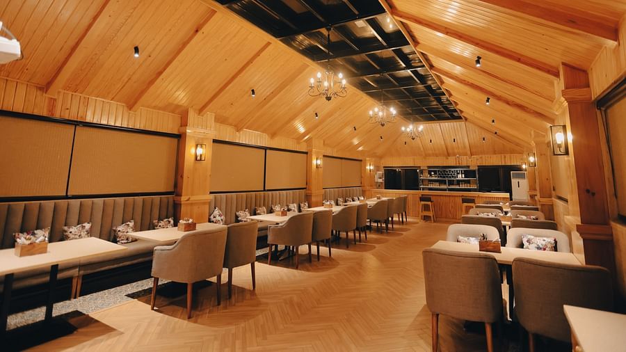 Clarks Inn Express Dehradun - interior view of the Clarks cafe featuring numerous seating options and yellow ambient lighting