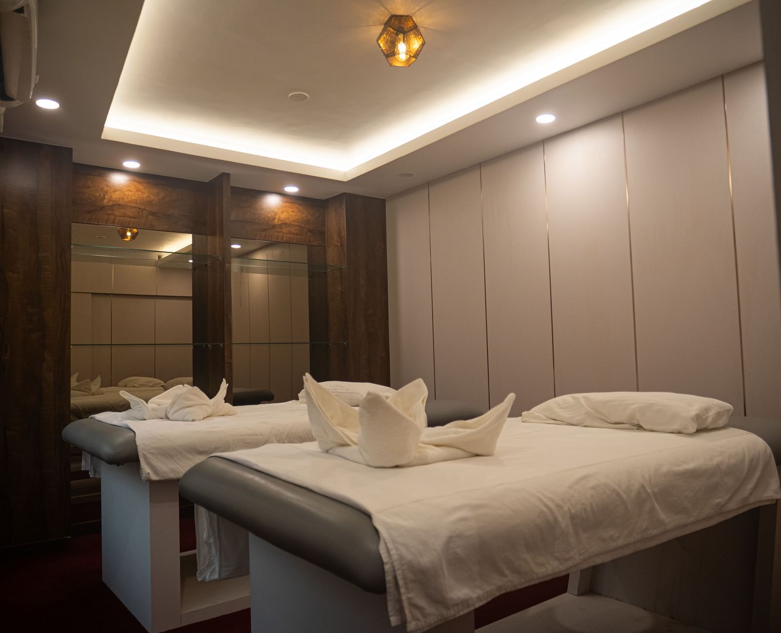 Spacious twin spa beds at Mansha Regency, Port Blair, with warm lighting and soothing ambience.