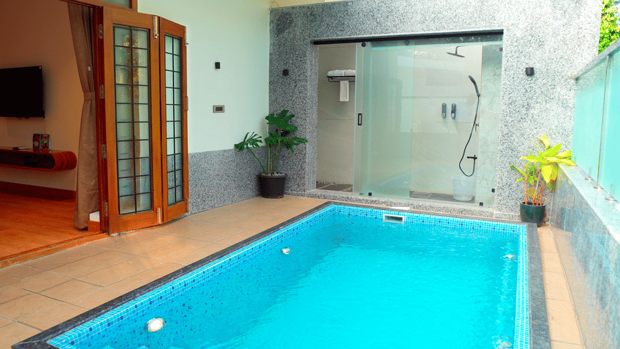 A private pool beside a room with open doors at DNC Shevaroys Resorts and Spa.