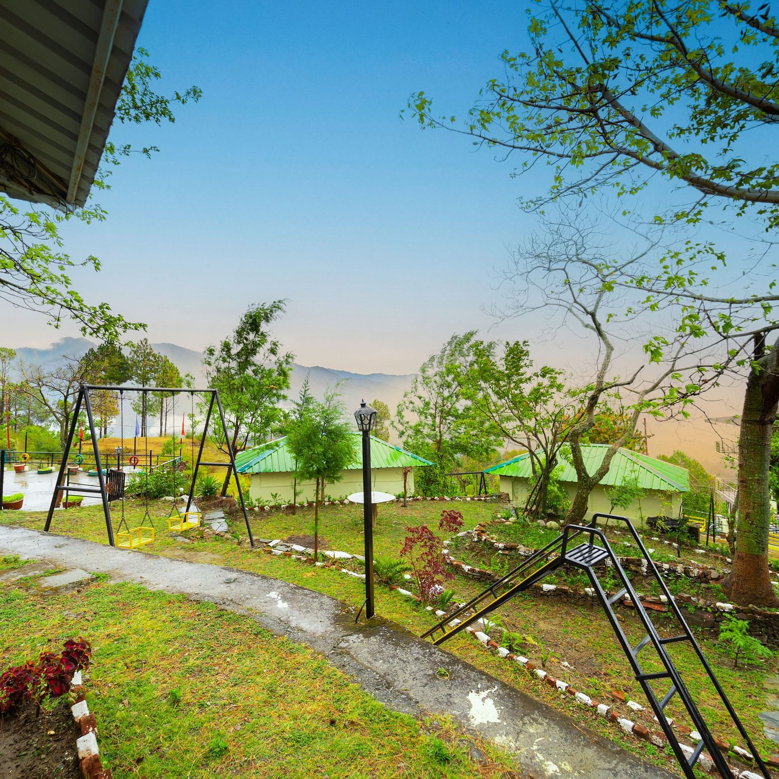 a view of a garden featuring a slide and a swing at Flutter Hotels & Resorts