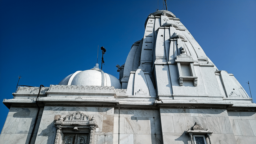 White marble Jain temple at Parasnath Hill featuring intricate architecture and a sacred pilgrimage setting atop the hill.