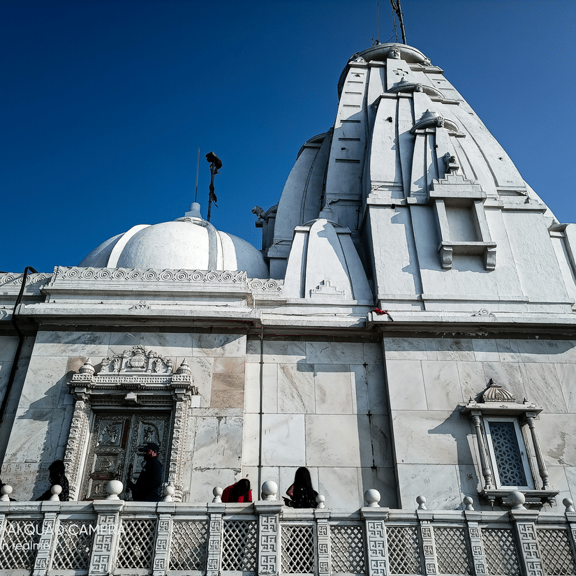 White marble Jain temple at Parasnath Hill featuring intricate architecture and a sacred pilgrimage setting atop the hill.