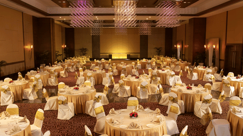 A banquet hall with round linen-covered tables set for a formal event at The Retreat Hotel and Convention Centre.