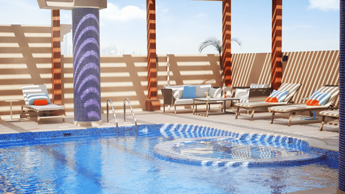 an overview of a swimming pool with loungers on the side - La Maison Hotel, Doha