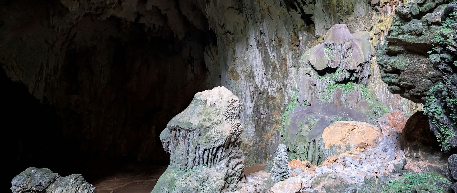 An overview of a limestone cave with stalagmites and stalactites seen inside.