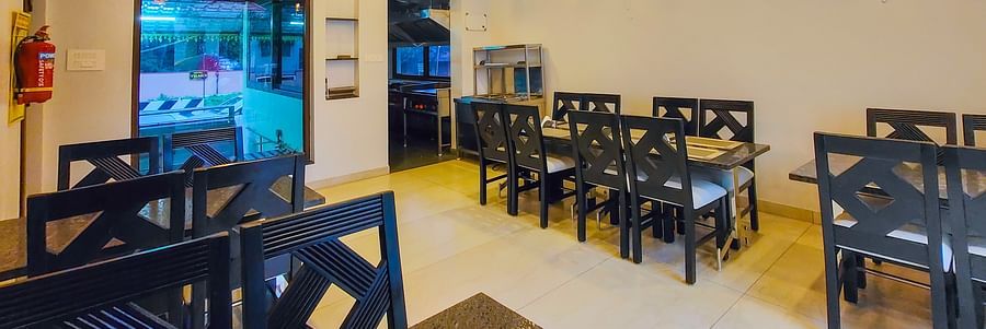 A brightly lit indoor dining area with wooden ceilings and neatly arranged tables - MGM Whispering Meadows