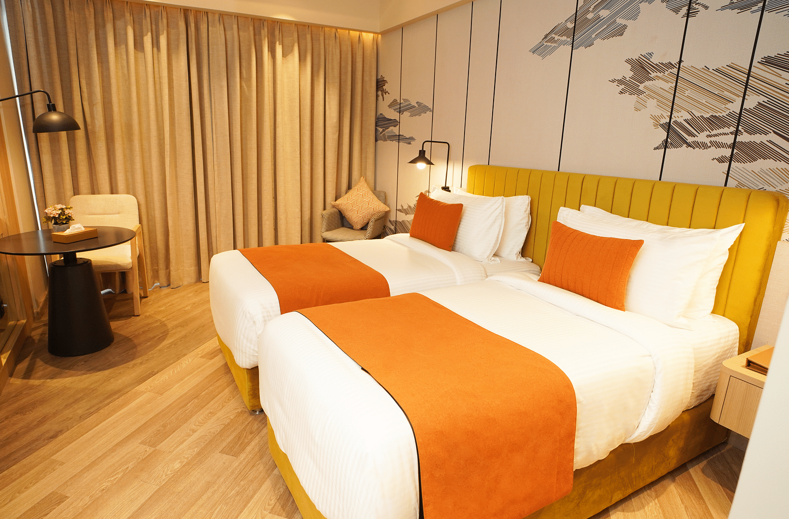 Twin beds with side table and curtains in a well-lit guest room - Ramada Encore by Wyndham Gurugram Dwarka Expressway