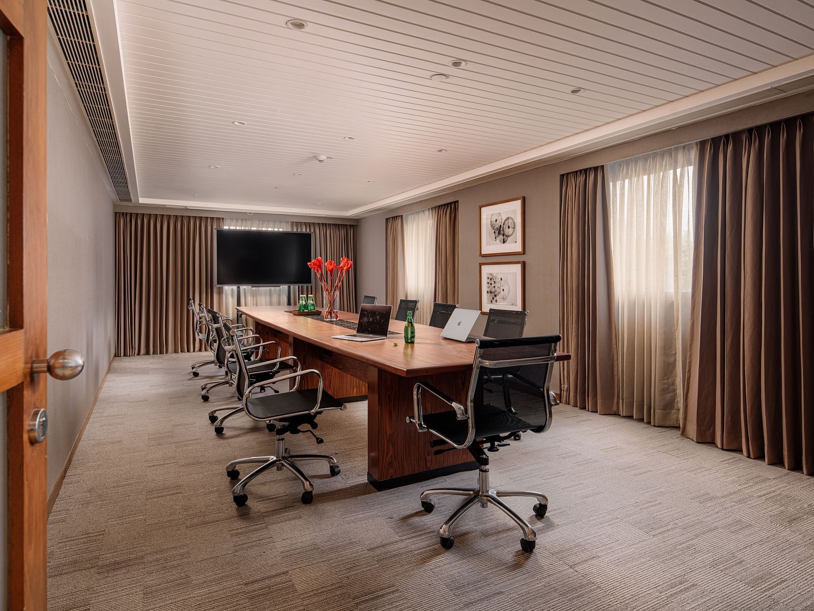 A well-appointed boardroom with a large conference table, equipped for productive meetings at The Raintree, St. Mary's Road.