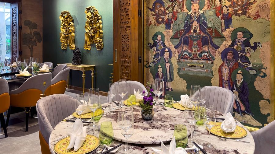 inside image of the jade restaurant with silver coloured chairs and a well decorated dining area - The Claridges New Delhi