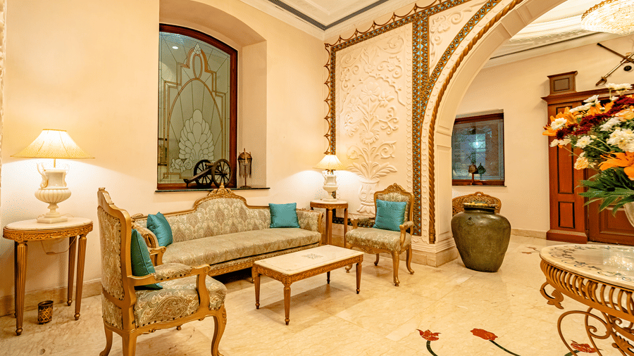 Side angle view of the couch set with a centre table in front of it in the lobby of Noor-Us-Sabah Palace, Bhopal.