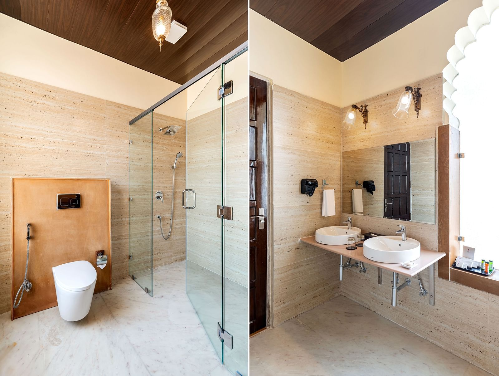 Spacious bathroom with glass shower, twin sinks, and golden lighting at Kesar Bagh Palace.