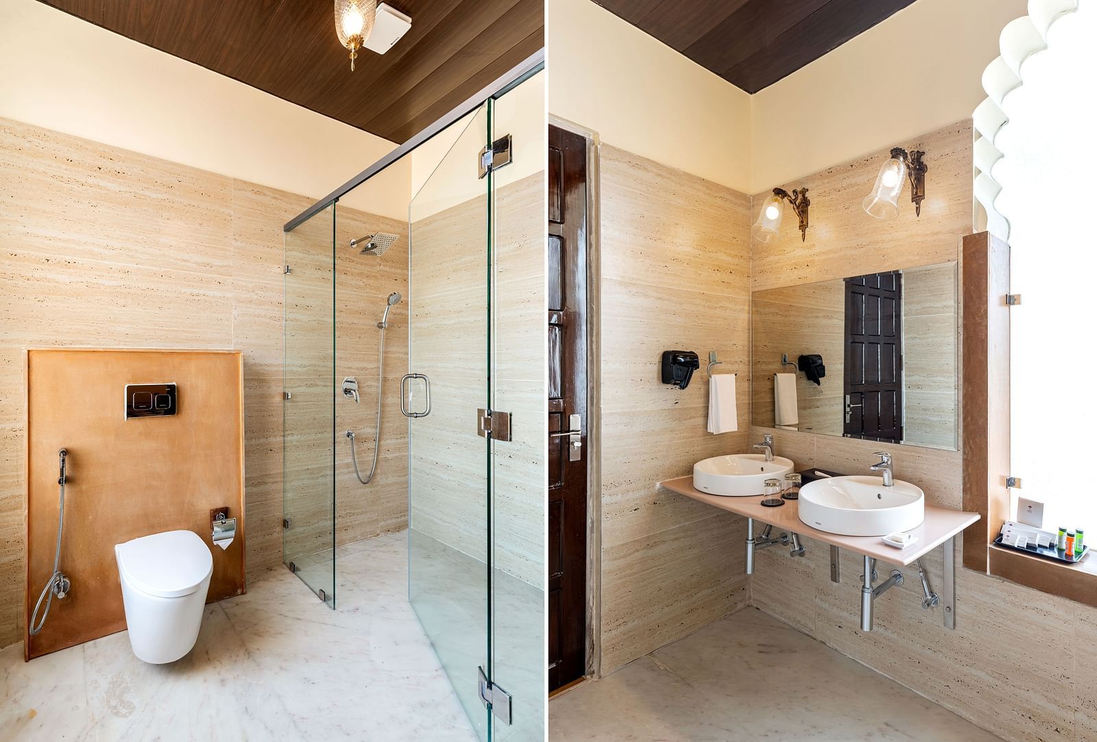 Spacious bathroom with glass shower, twin sinks, and golden lighting at Kesar Bagh Palace.