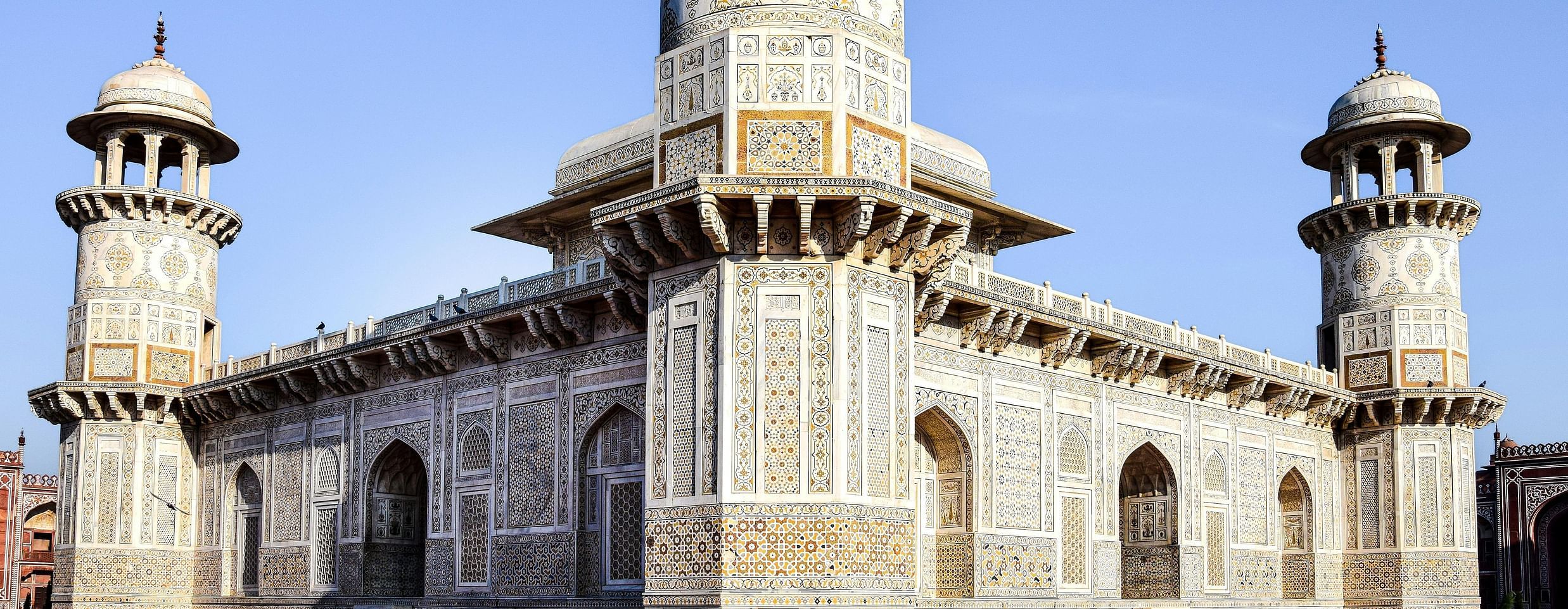 A grand, ancient building with intricate stonework and multiple towers