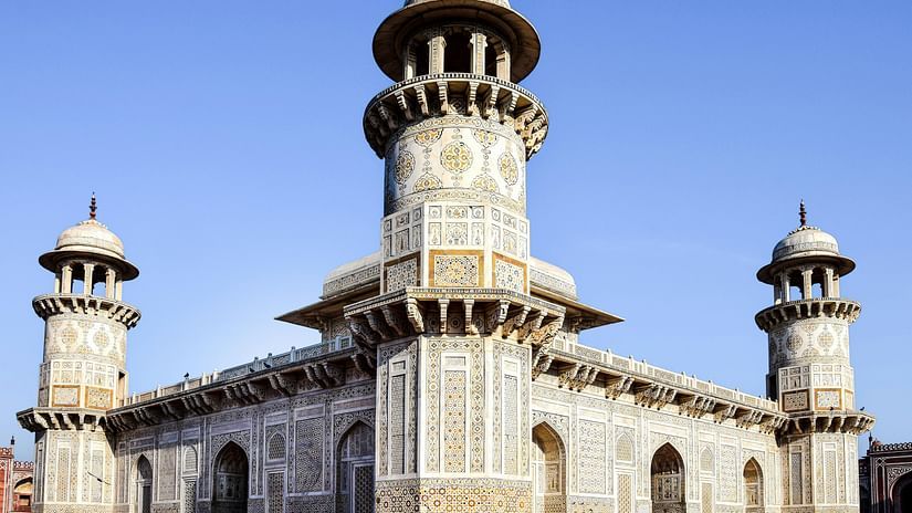 A grand, ancient building with intricate stonework and multiple towers
