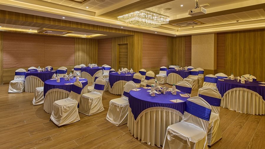 Another view of the round table seating in the banquet hall at Grand Continent - A Sarovar Premiere Affiliate Hotel, Hosur