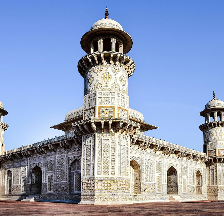 A grand, ancient building with intricate stonework and multiple towers