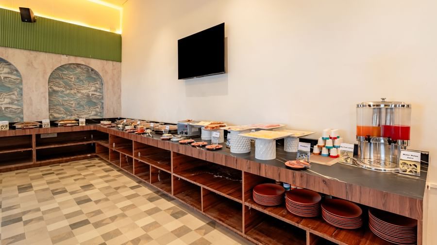 Buffet spread with various hot food options in chafing dishes | Pravasa Hotel, Vijayapura