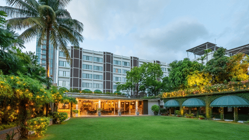 Facade of Kenilworth Hotel, one of the best Places to Stay in Kolkata, with a lawn in the foreground