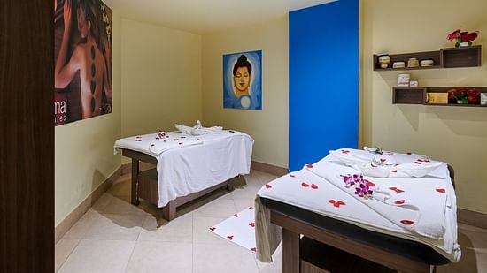 Interior of Sohum Spa at The Pride Hotel Nagpur featuring two spa beds with flower petals on them