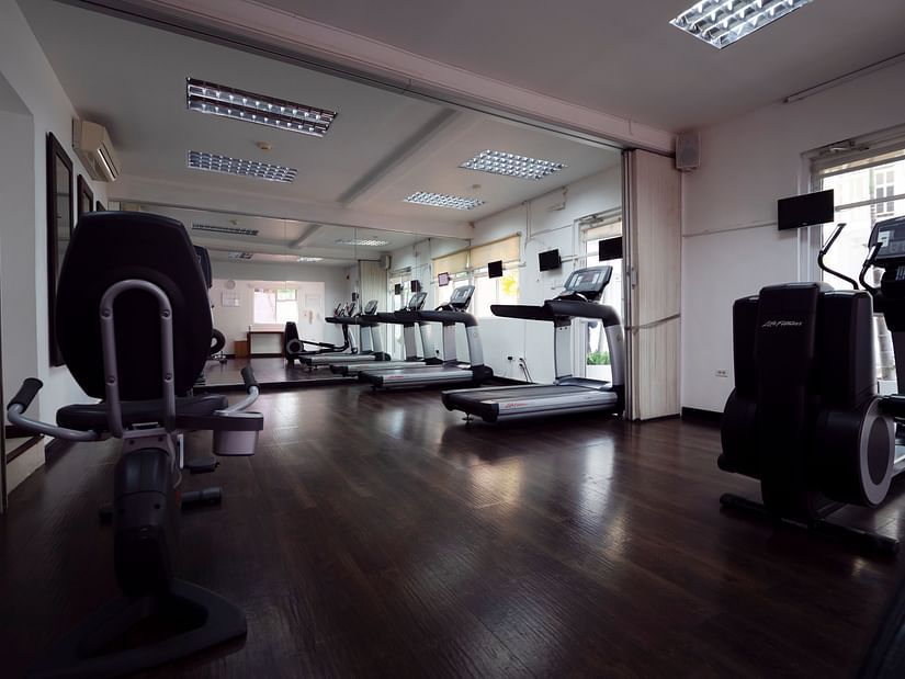 Spacious gym with various workout equipment and mirrored walls - S Hotel Kingston, Jamaica