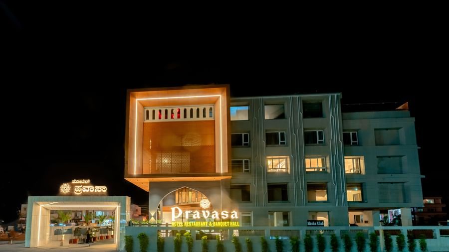 Facade of Pravasa Hotel at dusk with warm lighting | Pravasa Hotel, Vijayapura