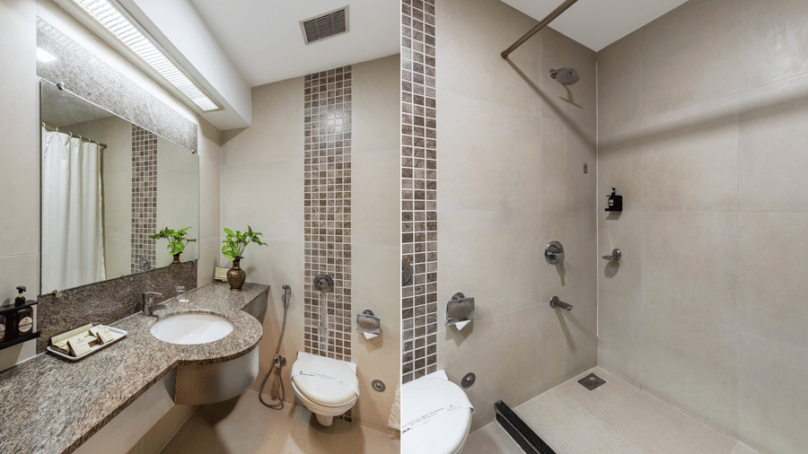 A collage of the modern bathroom of Comfort Room with a granite vanity area, large mirror, and a clean walk-in shower - Amantra Comfort Hotel