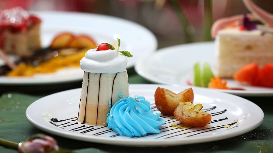 Desserts served on a plate with a cherry on the top at Uday Backwater Resort
