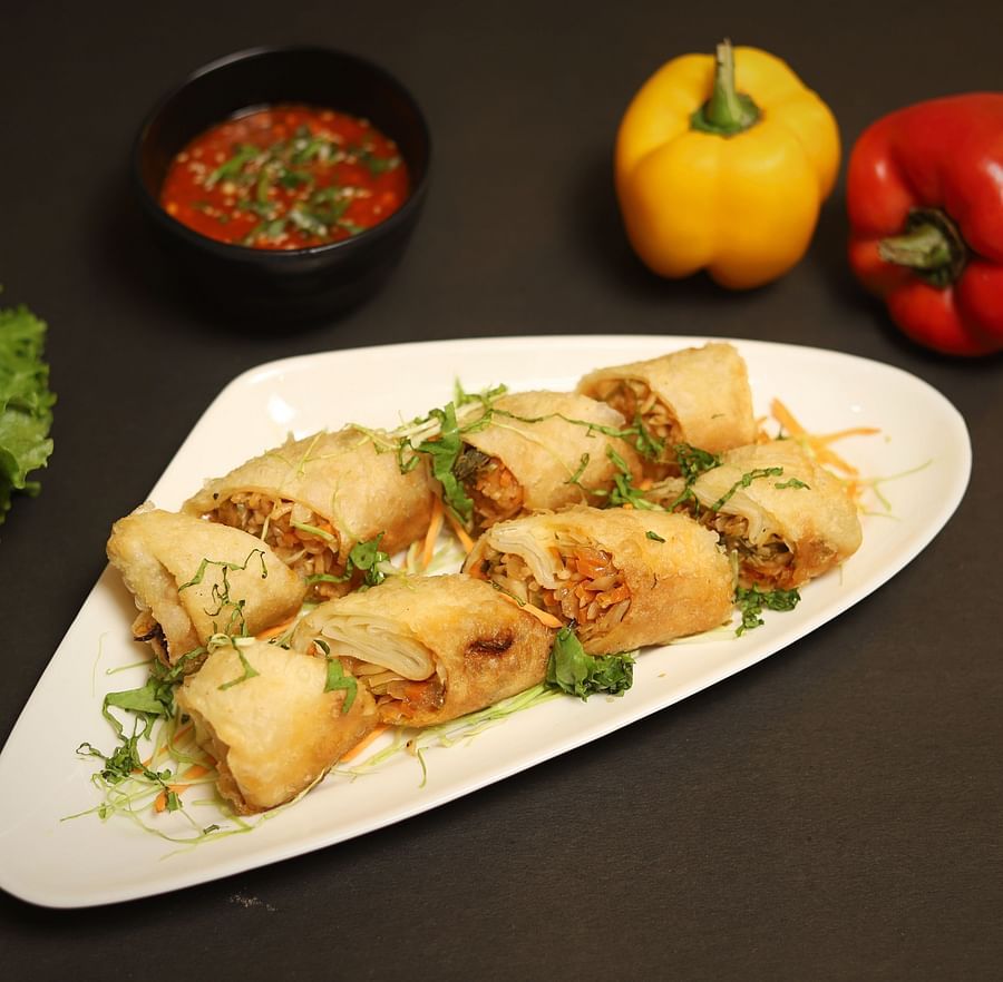 An image of spring rolls served in a platter at the restaurant of Five Elements Hotels North Avenue, Delhi