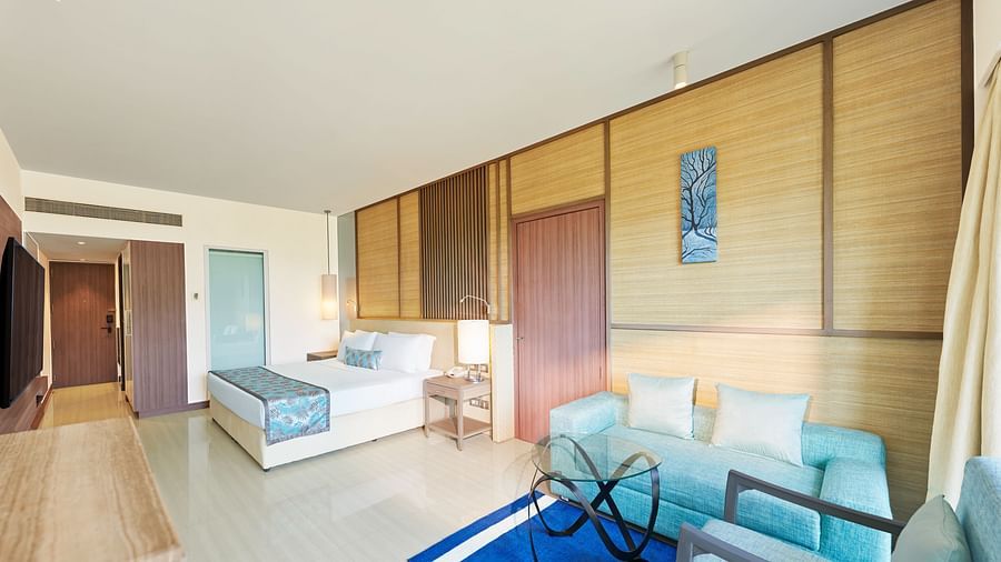 A bed and sofa in a room | The Resort