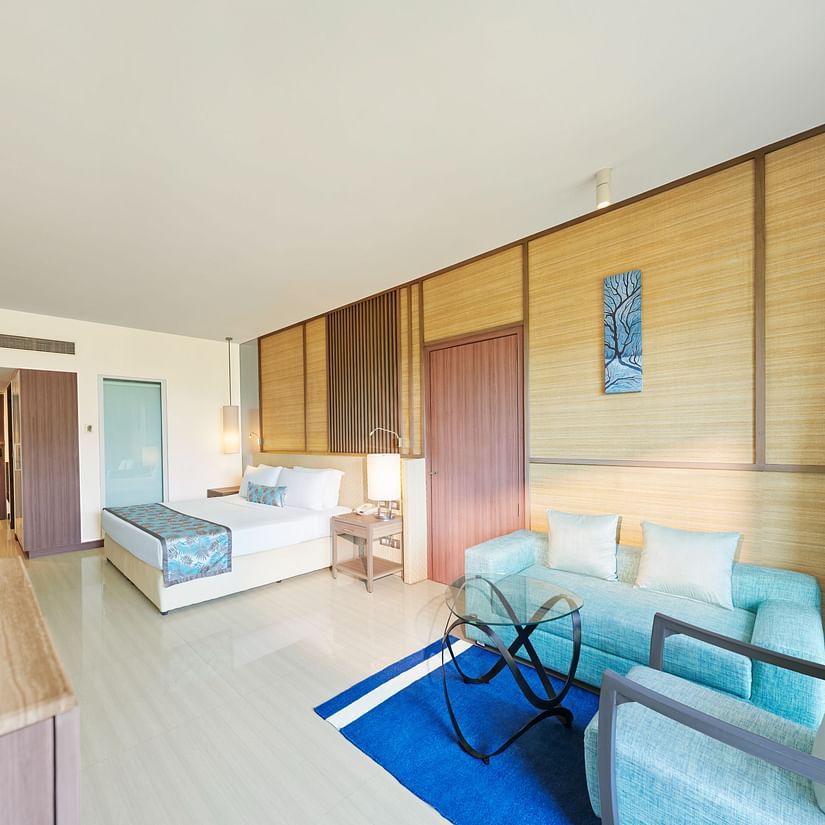 An image of a room with a bed, bed side tables, flat screen TV,  sofa set and a table - The Resort, Mumbai