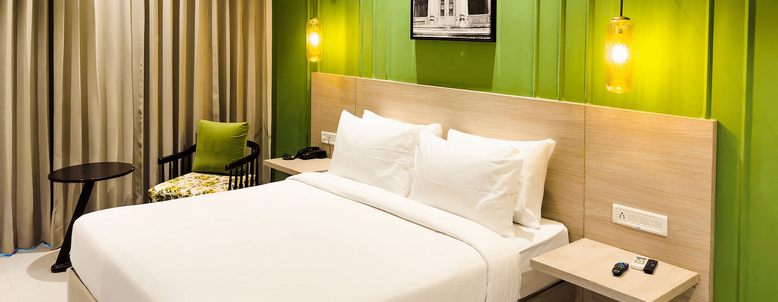 A view of the hotel room with a large bed, ambient light and comfortable furniture - Wonder Hills