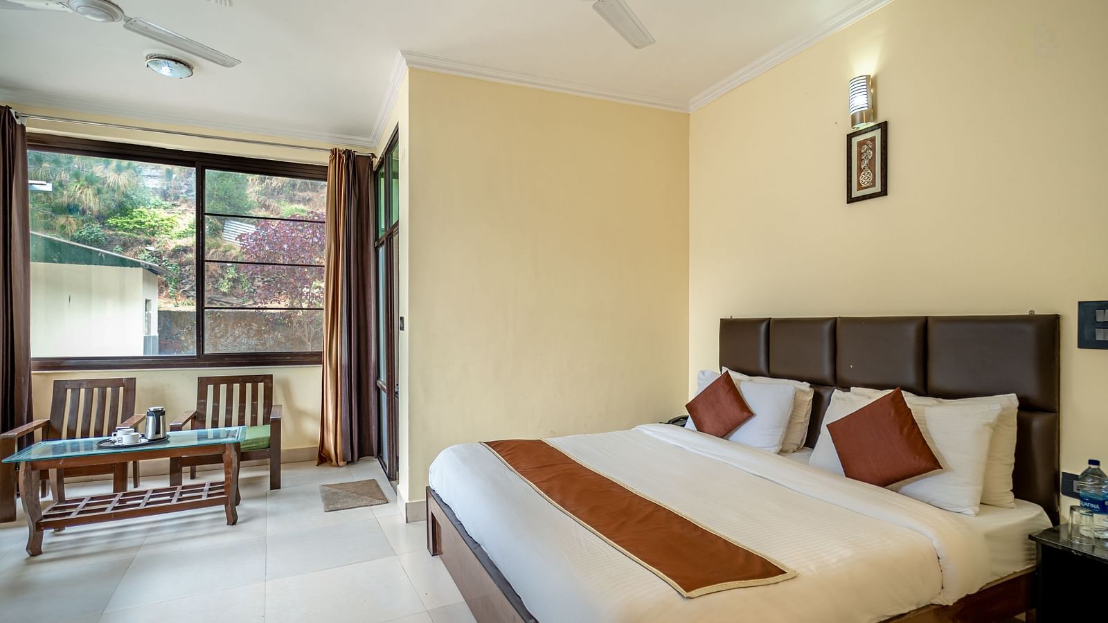 a plush bed overlooking a window at Flutter Hotels & Resorts