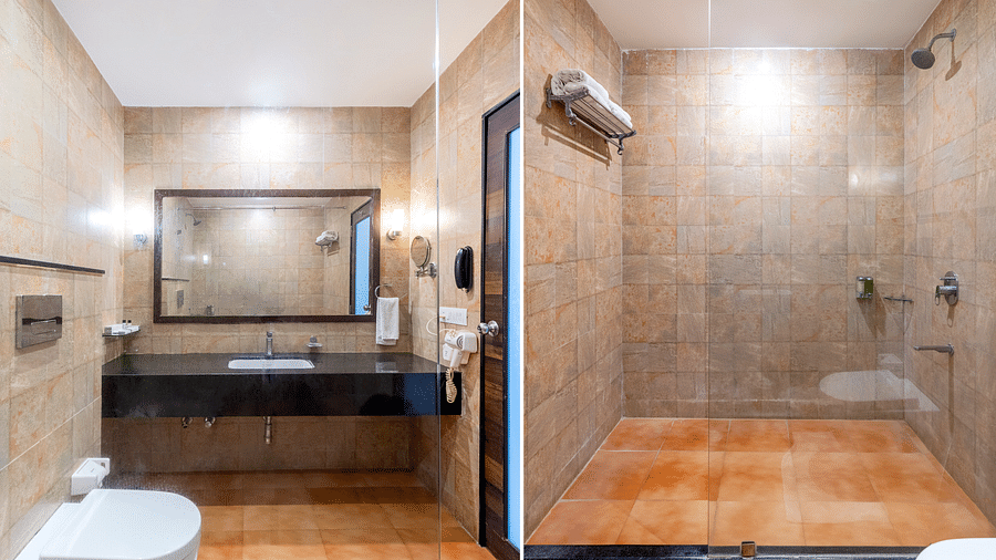 A bathroom with a glass shower door, toilet, and sink in a modern design - Via Lakhela Resort & Spa