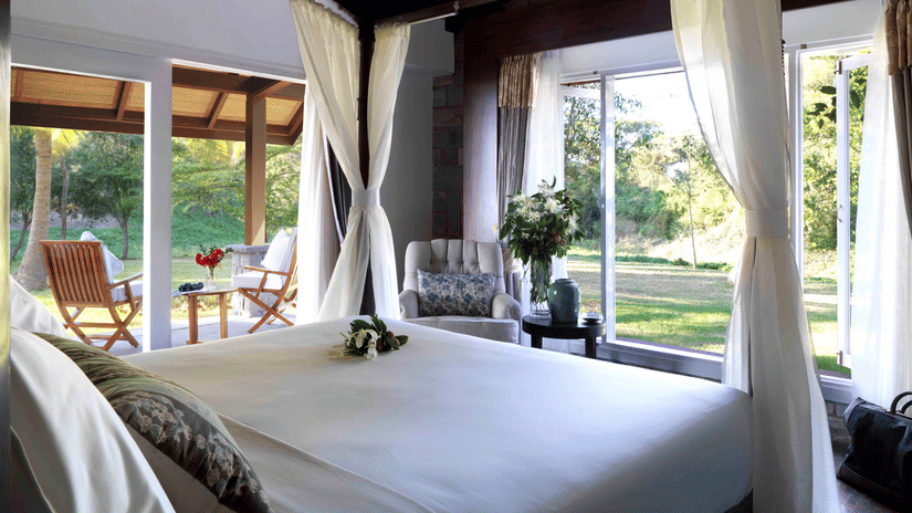 A view of bedroom and balcony of The Residence Room | The Serai Kabini