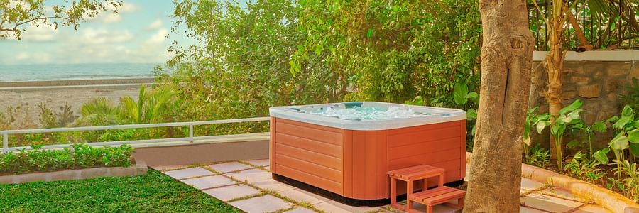 A jacuzzi near a tree during the day | The Resort