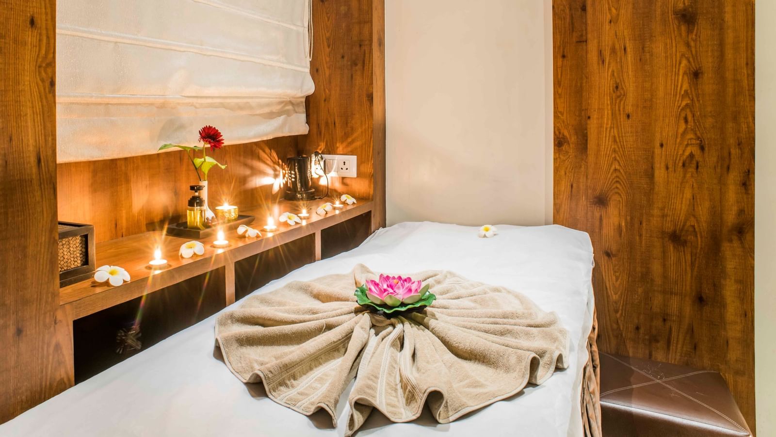 A neatly made bed with decorative elements in a room at The Citi Residenci Hotel, Durgapur.